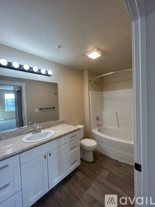 A bathroom with a sink, toilet, and bathtub.