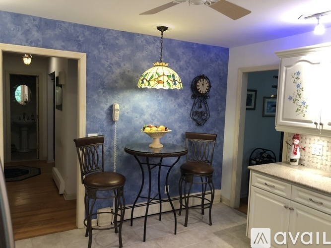 A dining area with a table and two chairs.