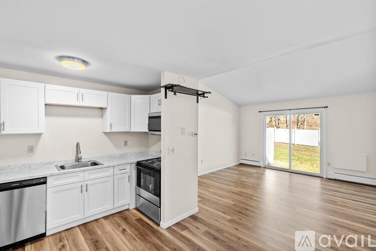 A kitchen with white cabinets and a black stove top oven.