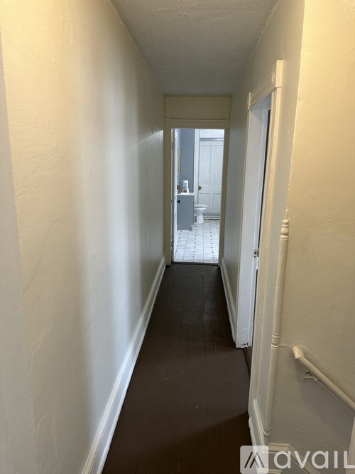 A long hallway with a door at the end.