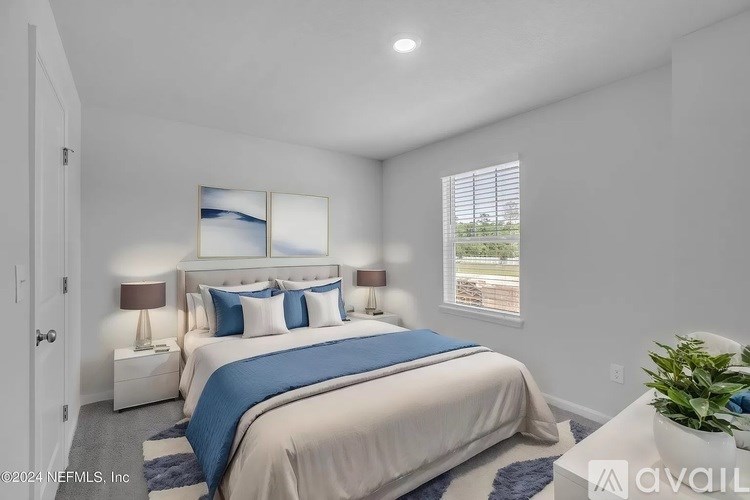 A bedroom with a large bed and a window.