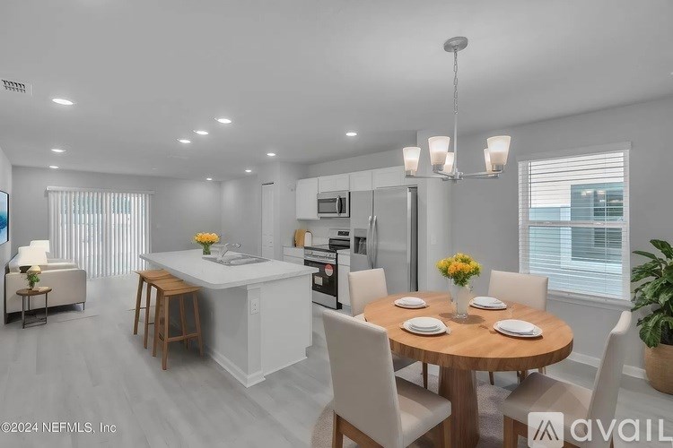 A modern kitchen with a dining table set for four.