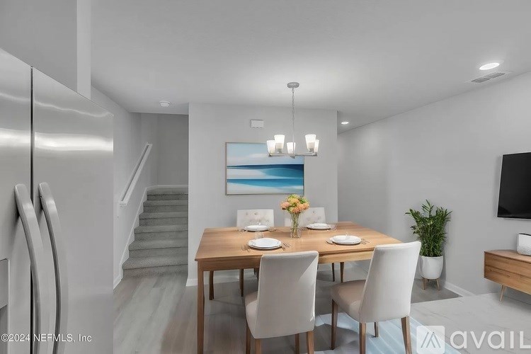 A modern dining room with a wooden table and chairs.