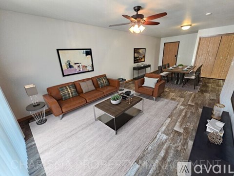 A living room with a brown sofa and a coffee table.