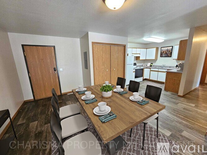 A dining room with a wooden table set for six.