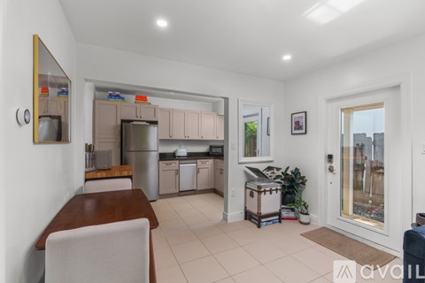 A kitchen with a dining table and chairs.
