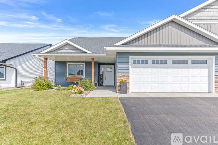 A house with a grey roof and a white garage door.
