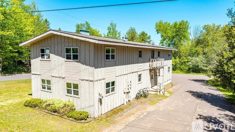 A two-story house with a garage on the side.