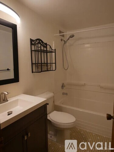 A bathroom with a toilet, sink, and bathtub.
