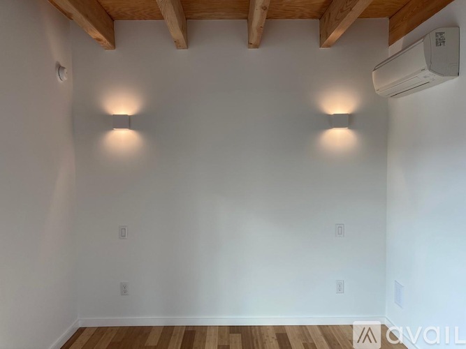 A kitchen with white cabinets and a stainless steel refrigerator.