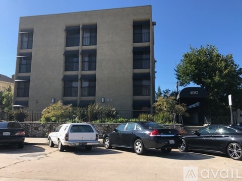 A building with cars parked in front of it.