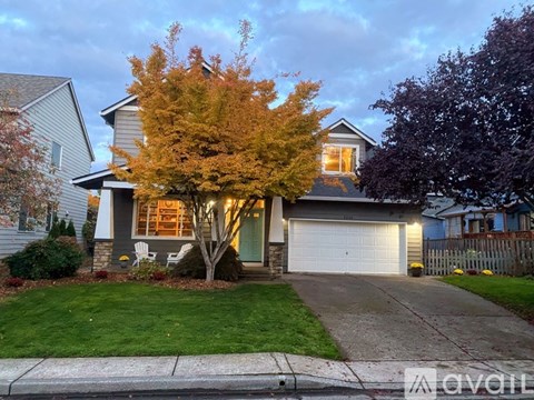 A house with a tree in front of it.
