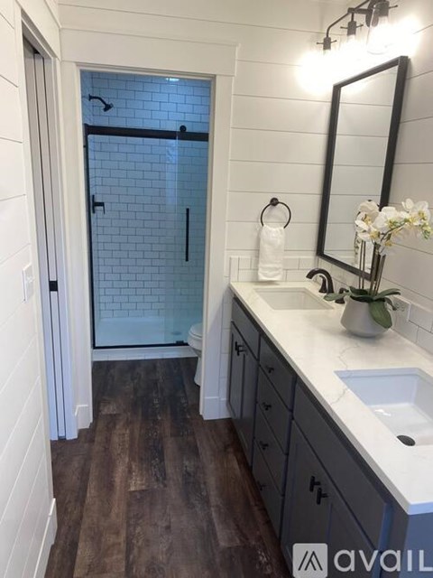 A bathroom with a white sink and a mirror.