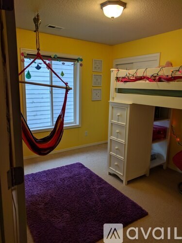A room with a hammock hanging from the ceiling.