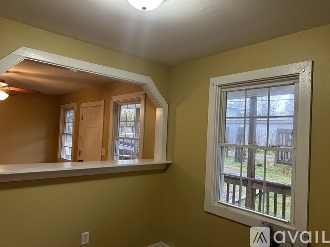A room with a window and a view of a deck.