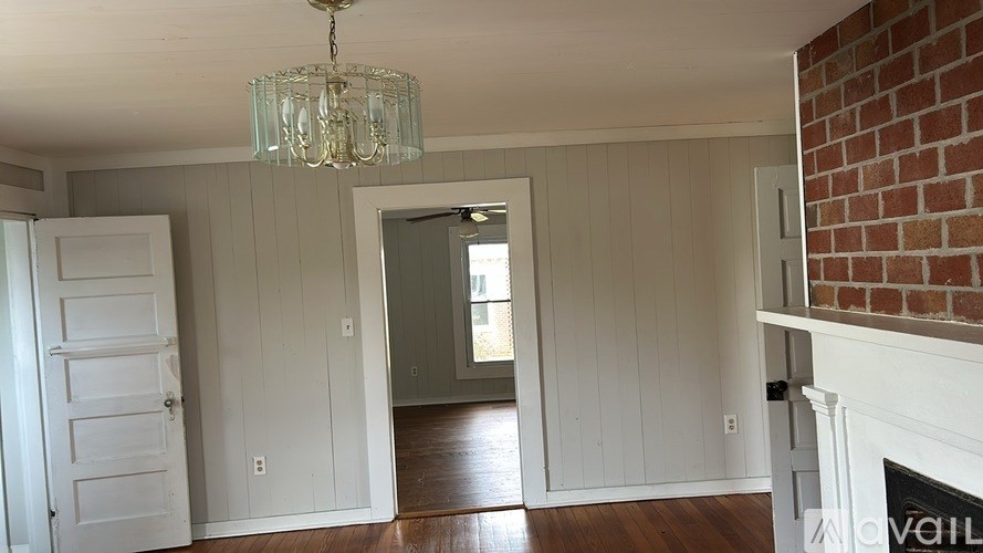 A room with a fireplace and a chandelier.