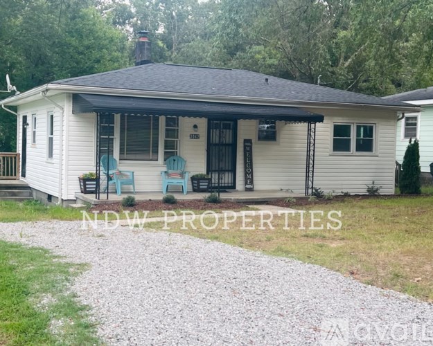 A house with the text NDW PROPERTIES on the front lawn.