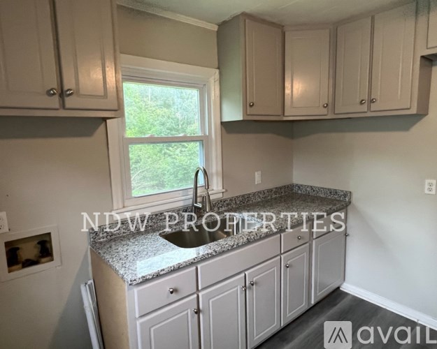 A kitchen with granite countertops and cabinets.