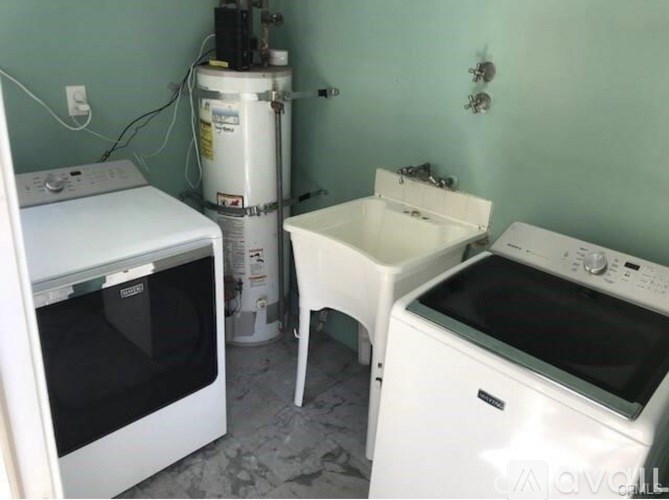 A white oven and a white dishwasher are in a kitchen.