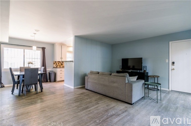 A living room with a grey couch and a television.