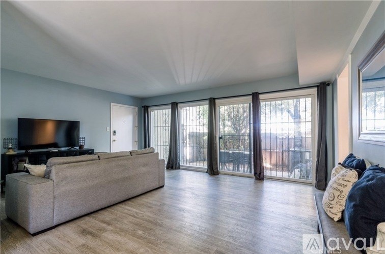 A living room with a grey couch and a television.