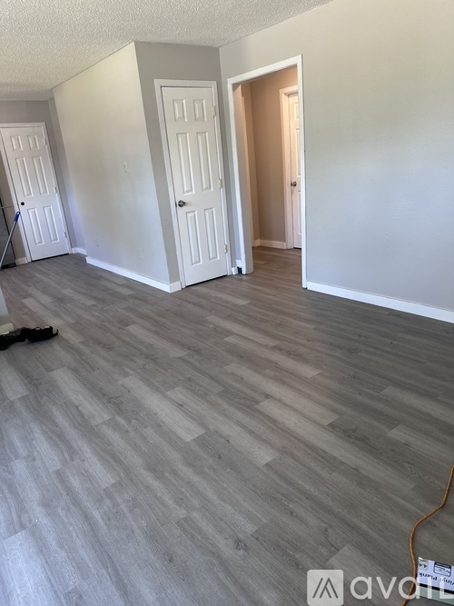 A room with a grey floor and white walls.