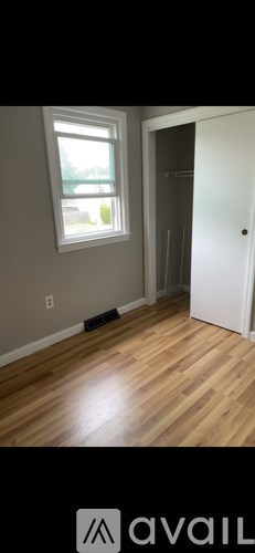 A room with a wooden floor and a window.