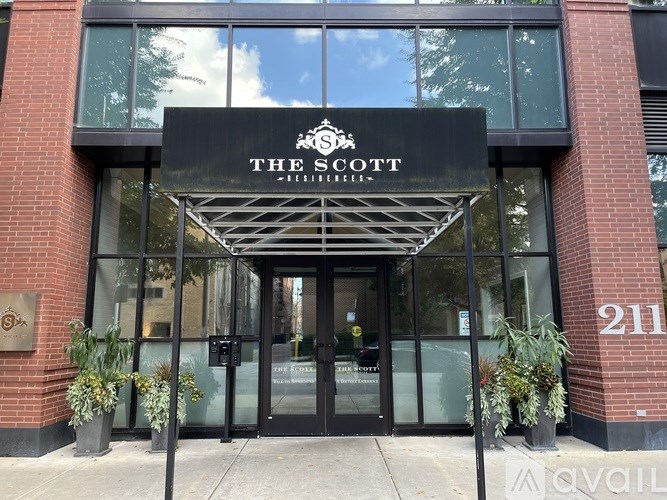 The front of a building with a black awning that says The Scotts.