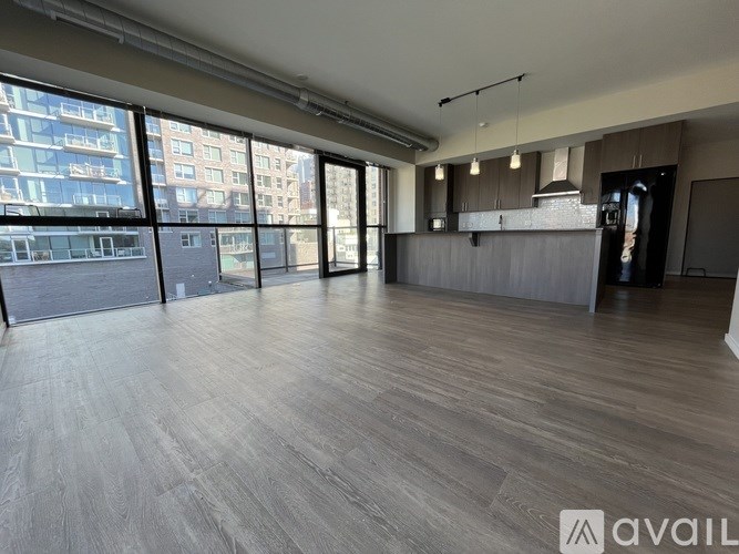 A modern kitchen with a bar area and a green couch.