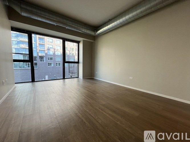 A hallway with wood flooring and white walls.