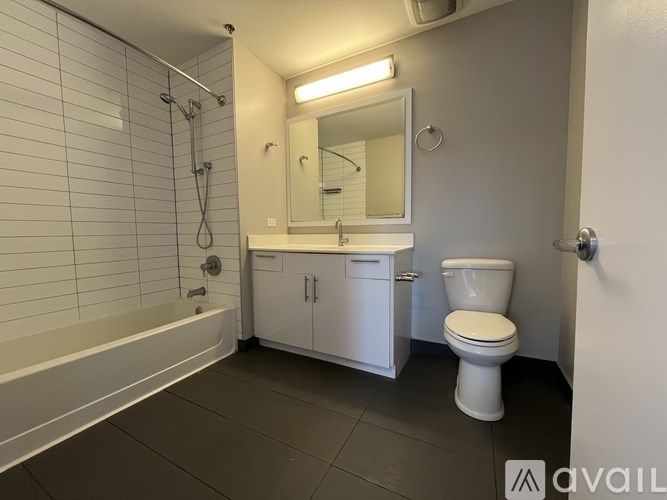 A rooftop patio with black chairs and tables.