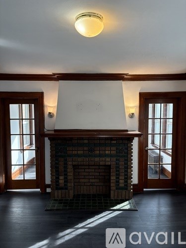 A room with a fireplace and a window.