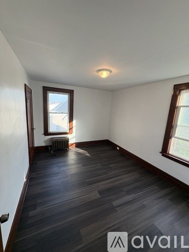 A room with wooden floors and a window.