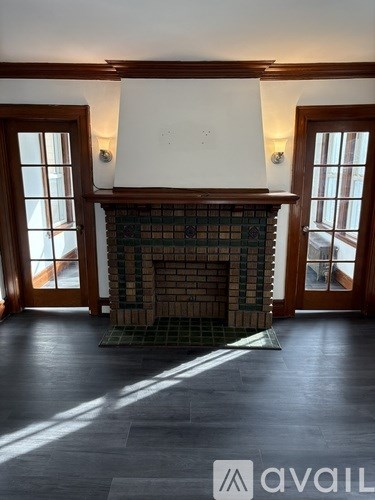 A room with a fireplace and a window.