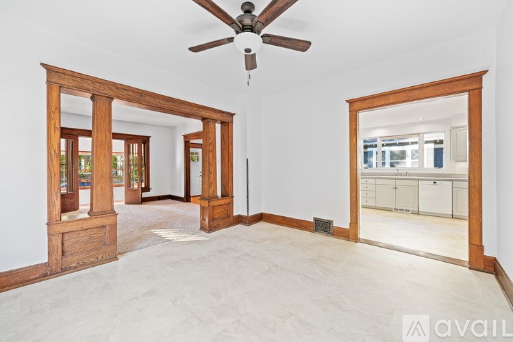 A room with a ceiling fan and a large mirror on the wall.