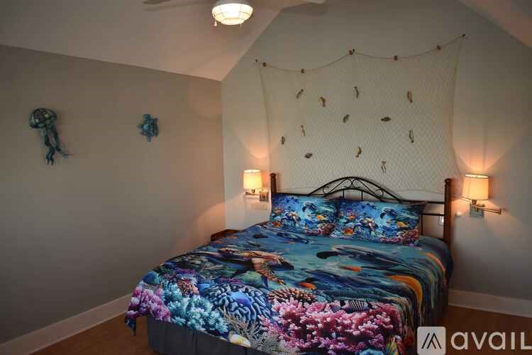 A bedroom with a bed covered in a floral print bedspread.