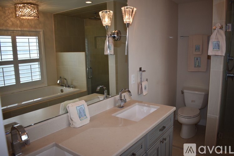 A bathroom with a sink, mirror, and toilet.