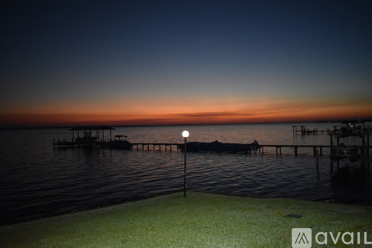 A dock with a light on it is in the water.