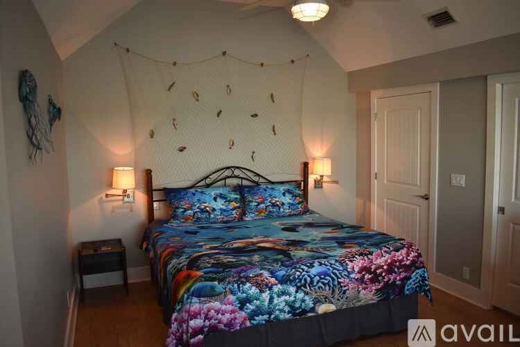 A bedroom with a bed covered in a floral print bedspread.