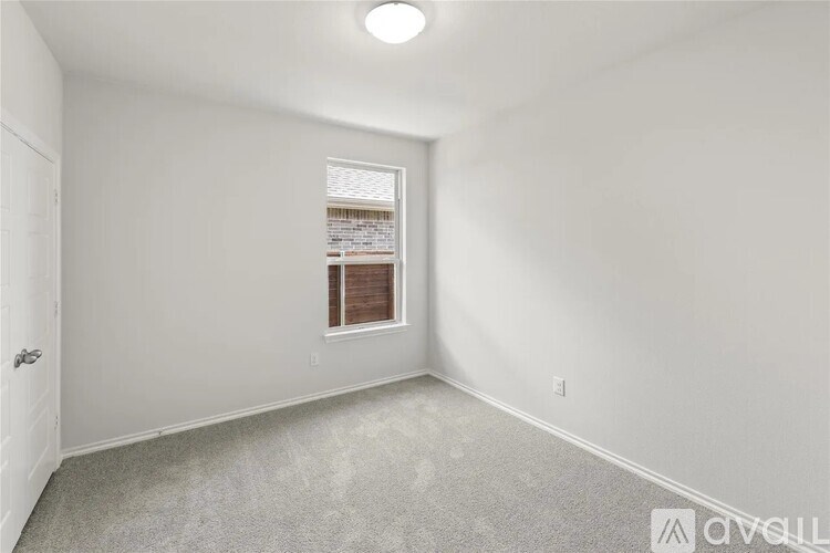 A white room with a window and a door.