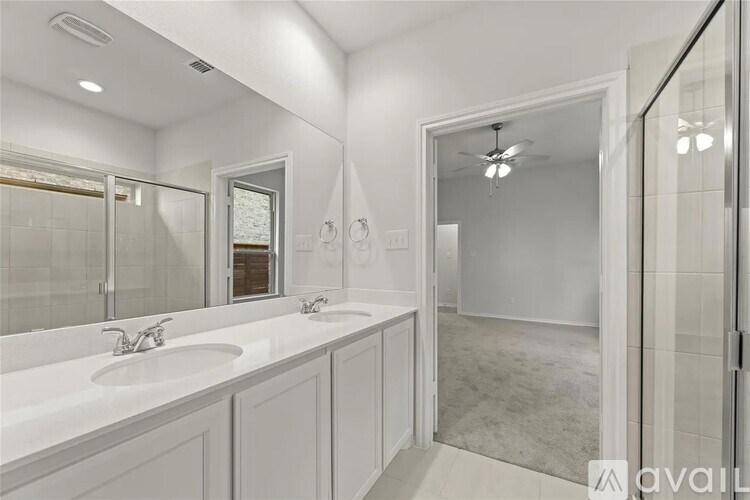 A bathroom with a white sink and a mirror.