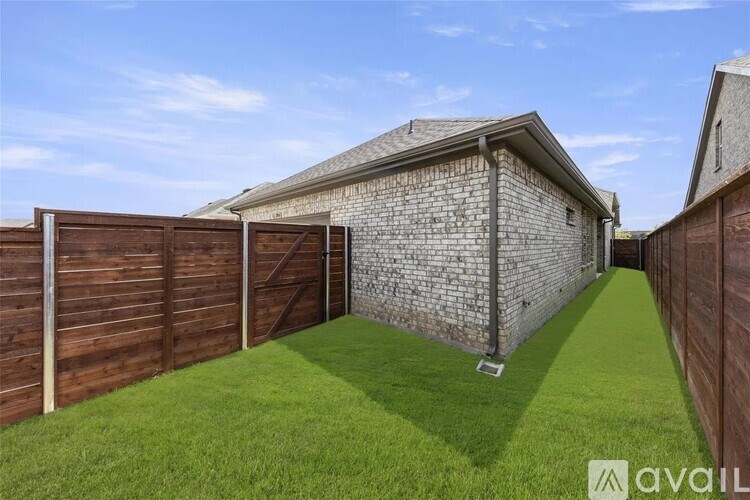 A house with a wooden fence and a brick wall.