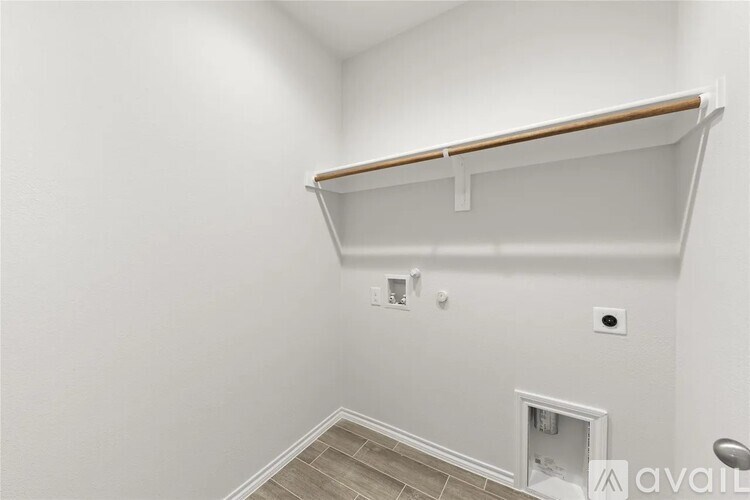 A white wall with a shelf and a doorway.