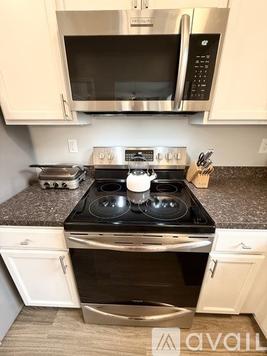 A kitchen with a stove top oven and microwave above it.