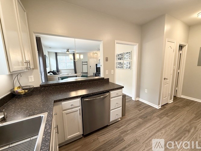A kitchen with a granite countertop and stainless steel appliances.