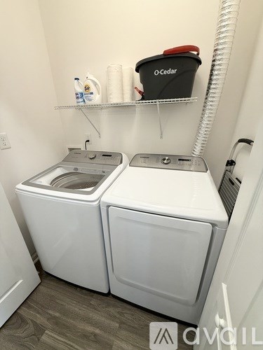 A white washer and dryer in a small laundry room.