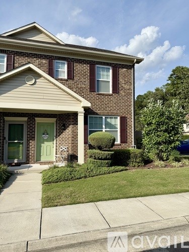 A house with a green door and a small front yard.