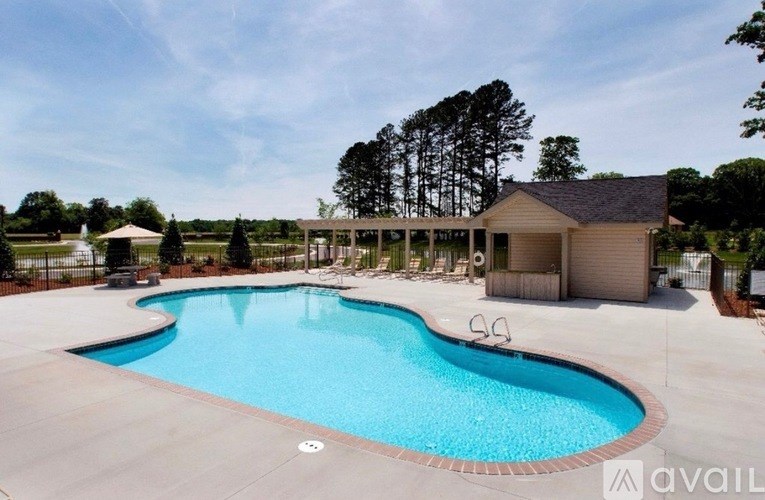 A large outdoor swimming pool with a building in the background.