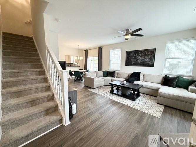 A living room with a staircase leading to the upper floor.