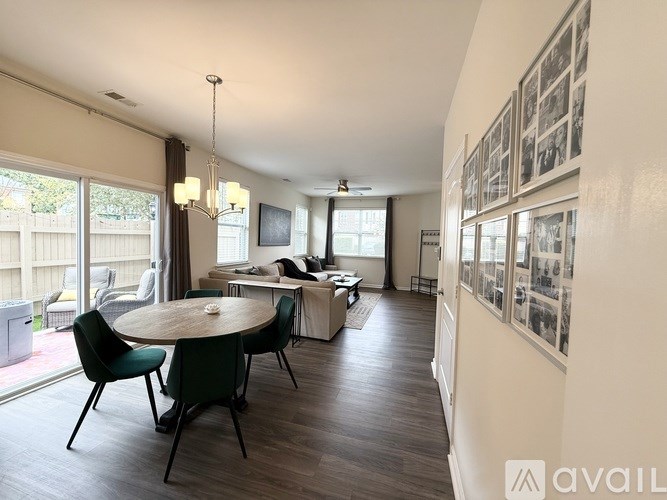 A living room with a dining table and chairs.